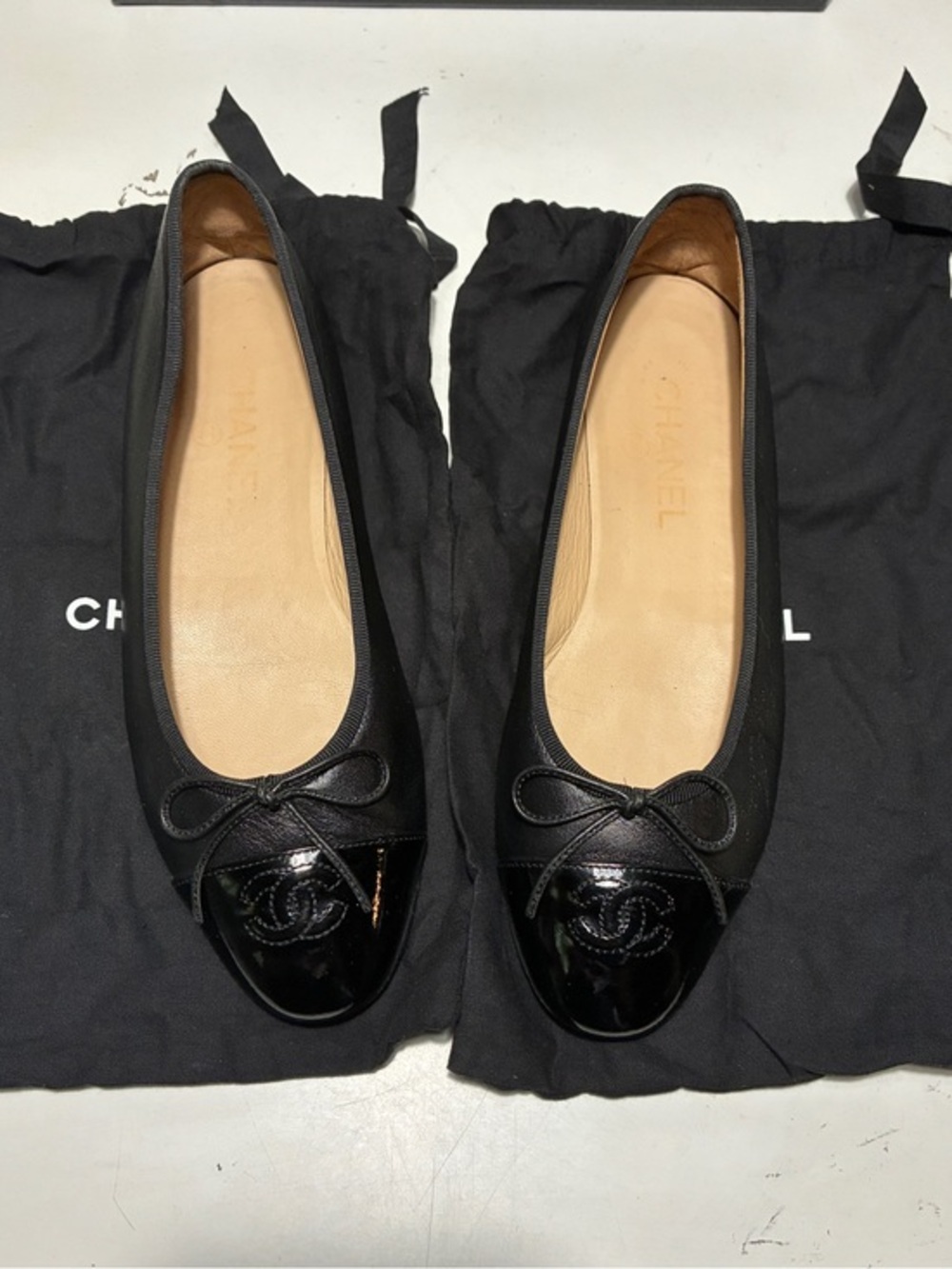 Chanel Black Ballet Flats with Patent Cap Toe and Bow Accent